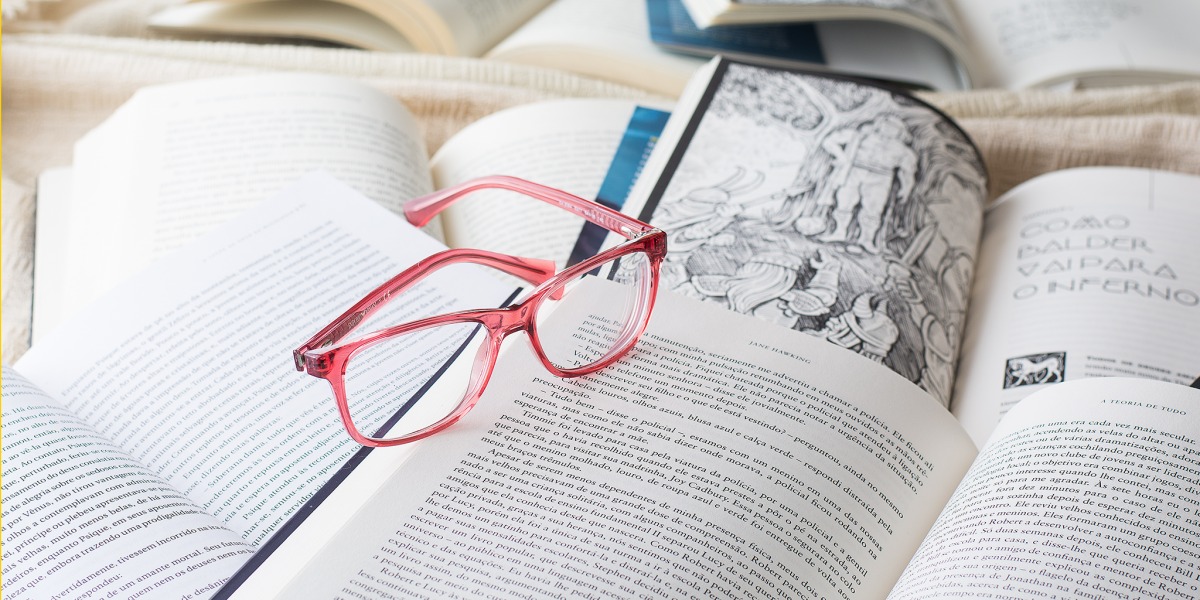 Reading glasses sitting on open books