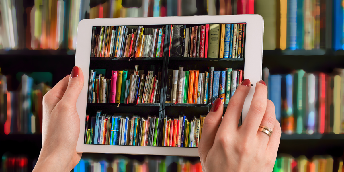 Person take a picture of books with a tablet.