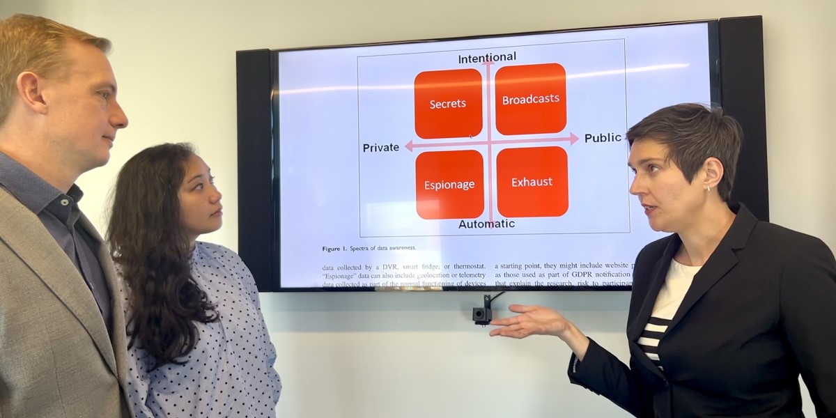 University of Maryland doctoral student Lovely-Frances Domingo, Professor Hal Daumé III and Associate Professor Katie Shilton discuss some of Shilton’s work on ethics and policy for the design of information technologies. Photo by Maria Herd