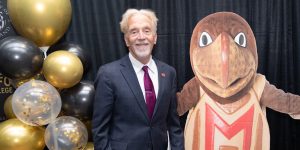 Photo of Keith Marzullo posing with UMD mascot testudo