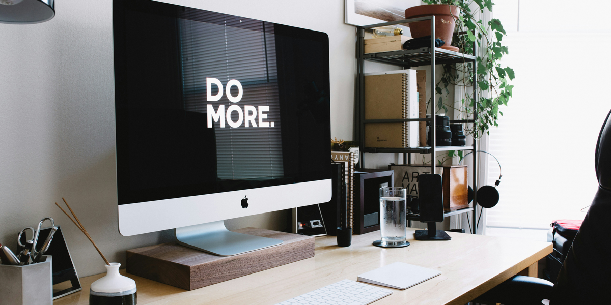 A mac desktop with the words "Do More" on the screen.