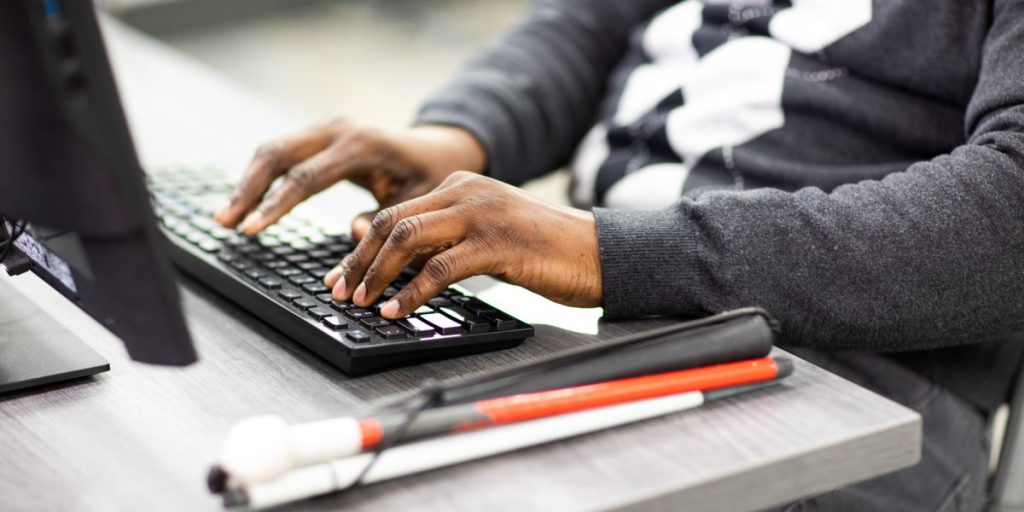 person typing on keyboard