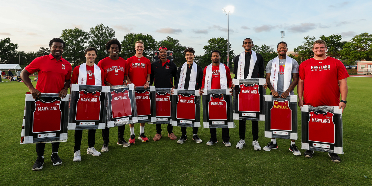 UMD Track & Field athletes holding awards.