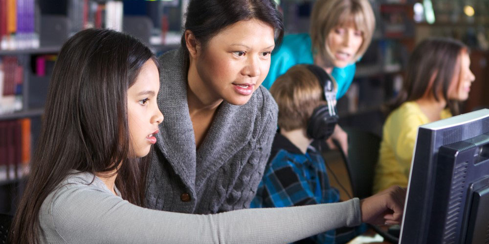 woman and child looking at a computer