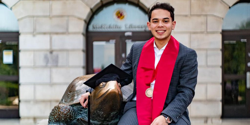 photo of Omar Youssef with the UMD Terp statue