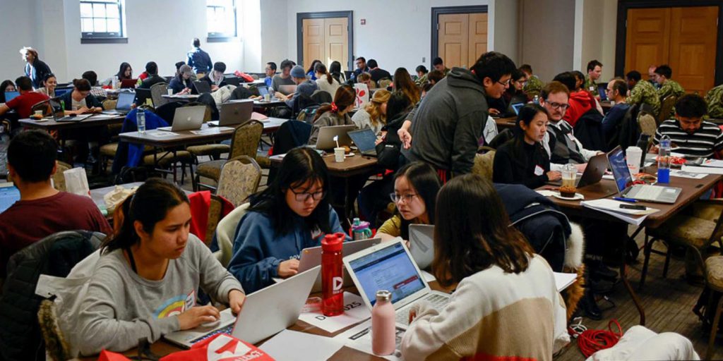 room of people sitting at tables on their laptops